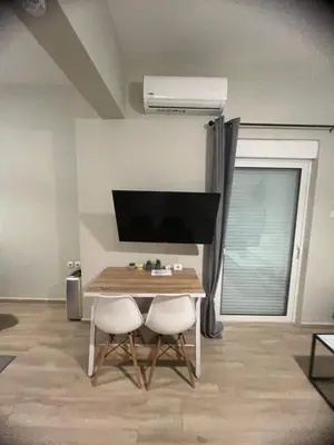 a dining room with a table and two chairs at Μοντέρνο διαμέρισμα στη Δάφνη in Athens