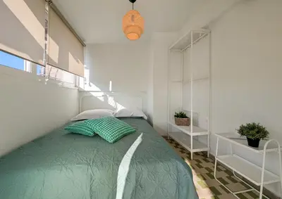 a bedroom with a bed with green pillows at Penthouse 4BD apt near Acropolis and metro in Athens