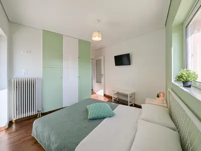 a bedroom with a large bed and a couch at Penthouse 4BD apt near Acropolis and metro in Athens