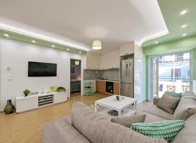 a living room with a couch and a table at Penthouse 4BD apt near Acropolis and metro in Athens