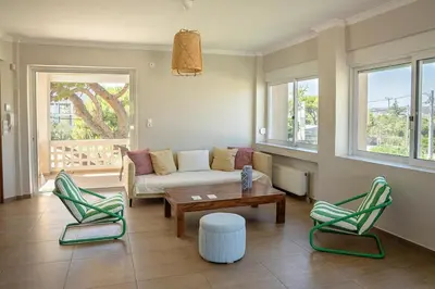 a living room with a couch and two chairs at Comfortable Villa - 2min from the Beach in Porto Rafti