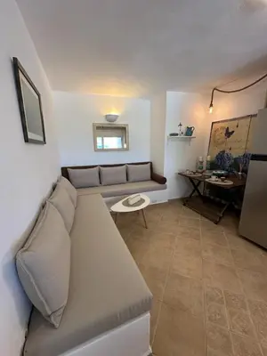 a living room with a couch and a table at Orris Seaside in Vaia