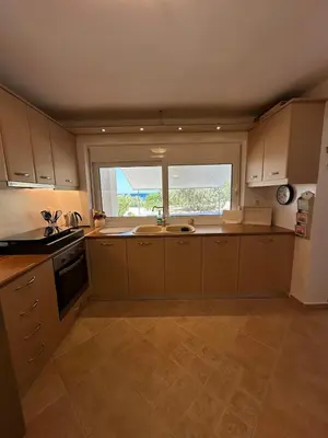 a kitchen with a sink and a window at Orris Seaside in Vaia