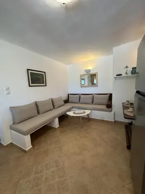 a living room with a couch and a table at Orris Seaside in Vaia