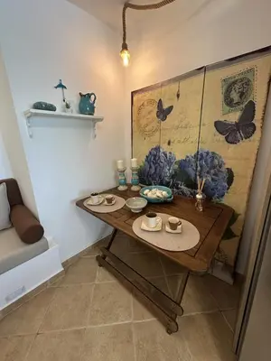 a room with a table with hats and plates on it at Orris Seaside in Vaia
