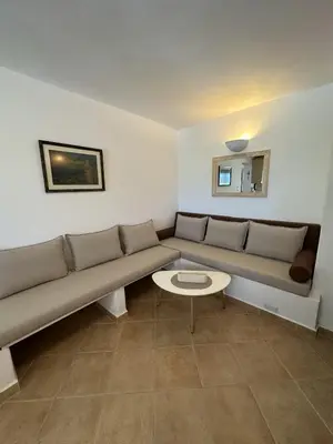 a living room with a couch and a table at Orris Seaside in Vaia