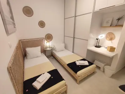 a small room with two beds and a desk at Theonisxenia Luxury Apt at Metro M3 in Athens