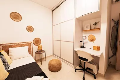 a bedroom with a bed and a desk in it at Theonisxenia Luxury Apt at Metro M3 in Athens
