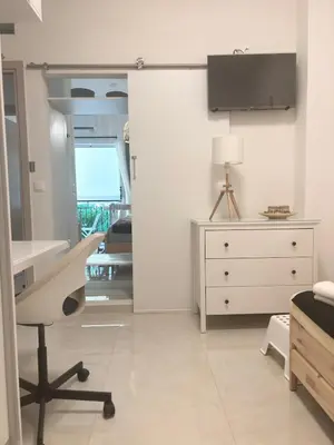 a white bedroom with a desk and a dresser at Theonisxenia Luxury Apt at Metro M3 in Athens