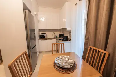 a dining room table with chairs and a bowl on it at Theonisxenia Luxury Apt at Metro M3 in Athens