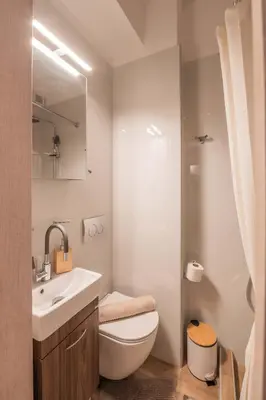 a bathroom with a white toilet and a sink at Theonisxenia Luxury Apt at Metro M3 in Athens