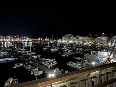 a marina at night with boats in the water at Piraeus Pearl - Seaview Elegance in Piraeus