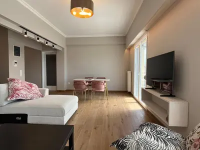 a living room with a couch and a table at Piraeus Pearl - Seaview Elegance in Piraeus