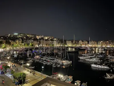 a group of boats docked in a marina at night at Piraeus Pearl - Seaview Elegance in Piraeus