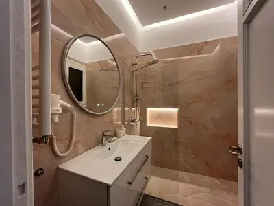 a bathroom with a sink and a mirror at Piraeus Pearl - Seaview Elegance in Piraeus