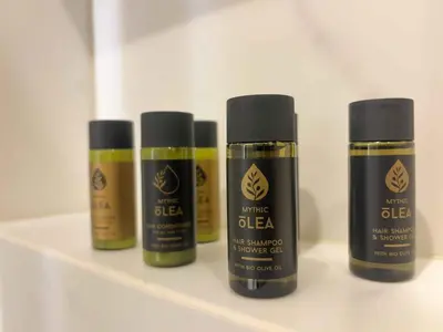 three bottles of white glue sitting on a shelf at Luxurious & Spacious Flat in Glyfada Center in Athens
