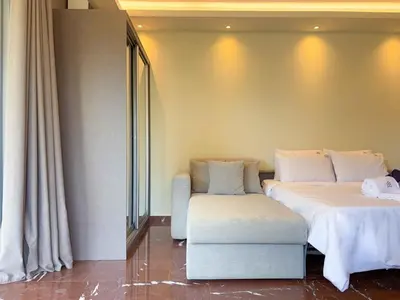 a room with two beds and a couch in it at Luxurious & Spacious Flat in Glyfada Center in Athens
