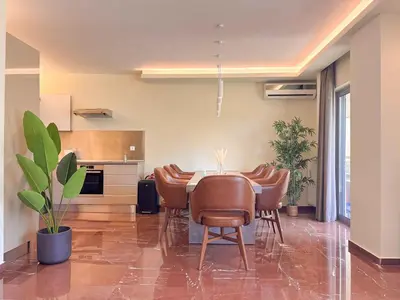 a kitchen with a table and chairs in a room at Luxurious & Spacious Flat in Glyfada Center in Athens
