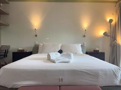 a large white bed with two towels on it at Luxurious & Spacious Flat in Glyfada Center in Athens