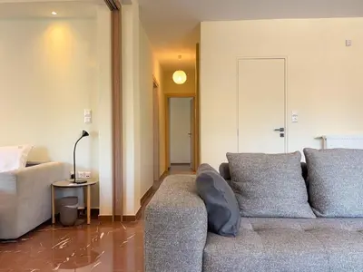 a living room with a couch and a bed at Luxurious & Spacious Flat in Glyfada Center in Athens