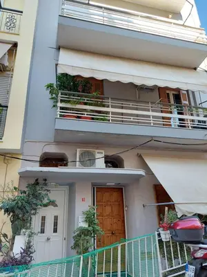 an apartment building with a balcony and a door at An's Piraeus port comfort apartment in Piraeus