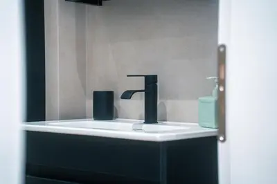 a sink with a faucet in a bathroom at Family Comfort Meets Modern style in Athens in Athens