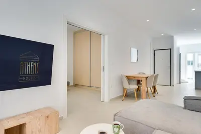 a living room with a couch and a table at Family Comfort Meets Modern style in Athens in Athens