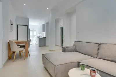 a living room with a couch and a table at Family Comfort Meets Modern style in Athens in Athens