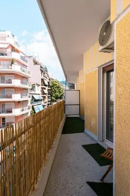 a balcony of a building with a wooden fence at Family Comfort Meets Modern style in Athens in Athens