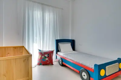 a bedroom with a bed with a toy bus at Family Comfort Meets Modern style in Athens in Athens
