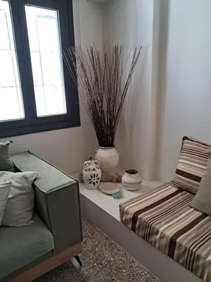 a room with a couch and a vase on a table at Athenian Stay 301 By VPN in Athens