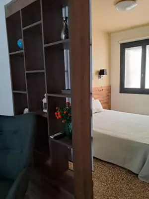 a bedroom with a bed and a book shelf at Athenian Stay 301 By VPN in Athens