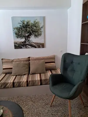 a living room with a couch and a chair at Athenian Stay 301 By VPN in Athens