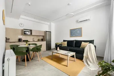 a living room with a couch and a table at The Magnificent Exarchia Loft Apartments in Athens