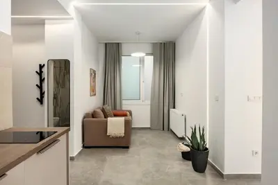 a living room with a couch and a chair at The Magnificent Exarchia Loft Apartments in Athens