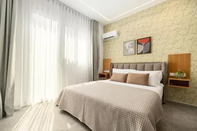 a bedroom with a large bed and a window at The Magnificent Exarchia Loft Apartments in Athens