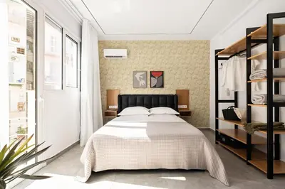a bedroom with a bed and a book shelf at The Magnificent Exarchia Loft Apartments in Athens