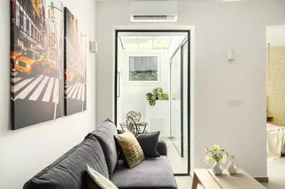 a living room with a couch and a door at The Magnificent Exarchia Loft Apartments in Athens