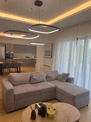 a living room with a couch and a table at New apartment in Athens