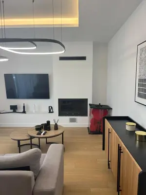 a living room with a couch and a table at New apartment in Athens