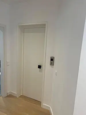 an empty room with a door in a white wall at New apartment in Athens