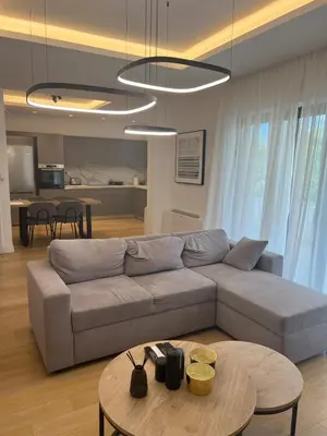 a living room with a couch and a table at New apartment in Athens