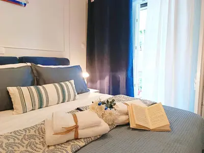 two beds with towels and books on top of them at Kalliopi Studio in Athens