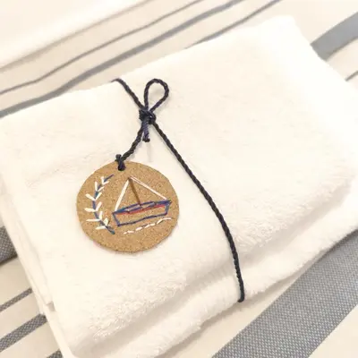 a button on a napkin on a table at Kalliopi Studio in Athens