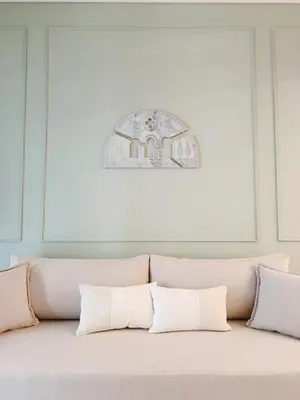 a couch with two pillows in a room at Kalliopi Studio in Athens