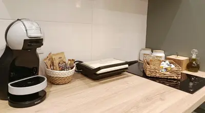 a kitchen counter with a coffee maker and baskets of food at Kalliopi Studio in Athens