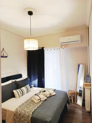 a bedroom with a large bed with pillows on it at Kalliopi Studio in Athens