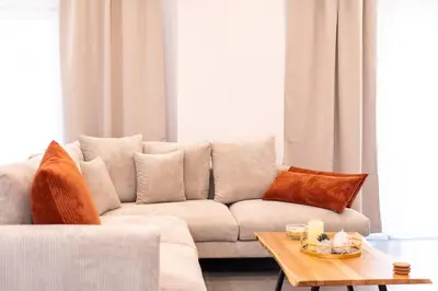 a living room with a couch and a table at Eleni's Cozy Apartments Near Athens Airport By SEM in Koropíon