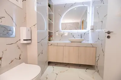 a bathroom with a toilet and a sink at Eleni's Cozy Apartments Near Athens Airport By SEM in Koropíon
