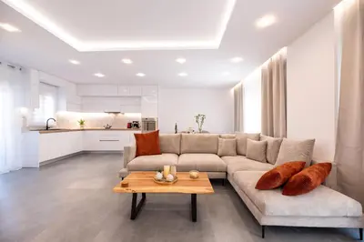 a living room with a couch and a table at Eleni's Cozy Apartments Near Athens Airport By SEM in Koropíon
